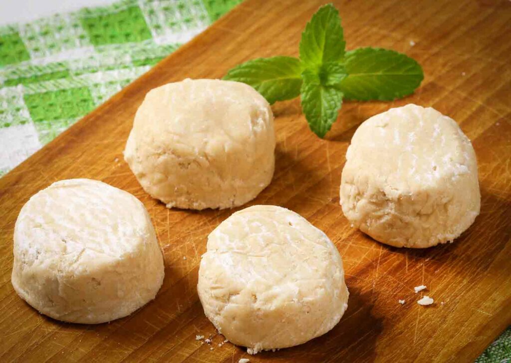 Filipino polvoron delicacy on a wooden cutting board