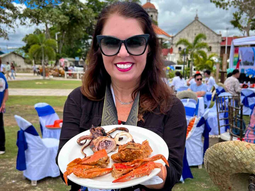 Ayngelina with a plate of traditional south Cebu foods outside in Dalaguete