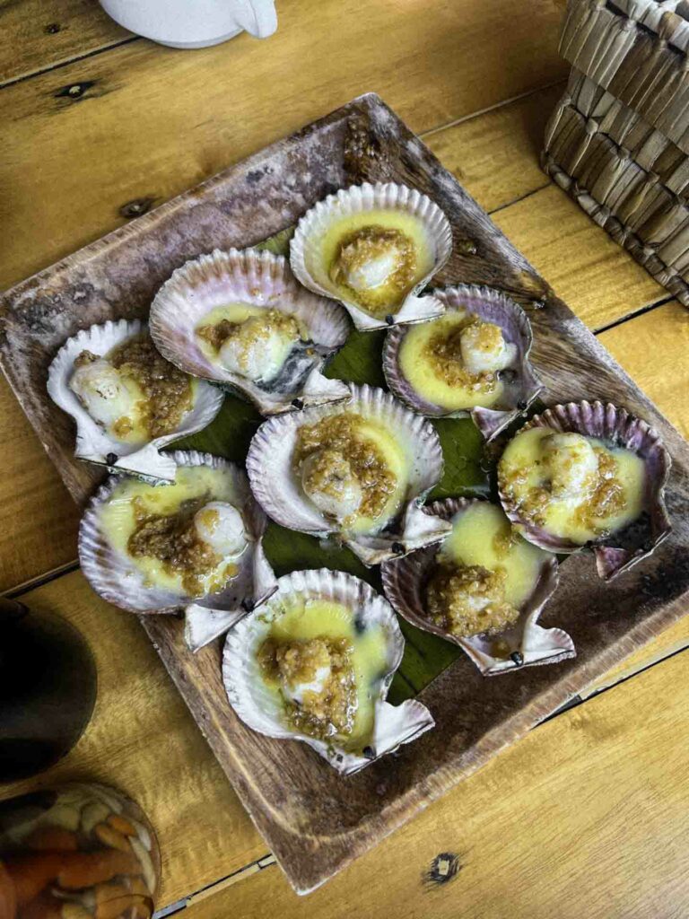 9 baked scallops on baking sheet at dining table in Dumaguete