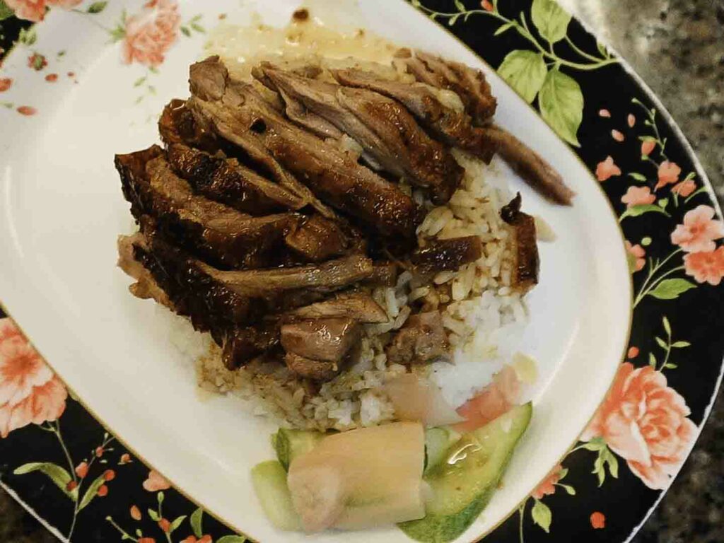 Roasted duck and rice on plate in Bangkok restaurant PRACHAK PET YANG