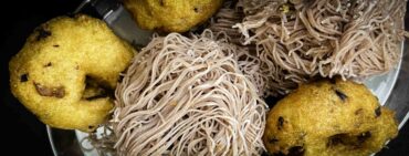 Jaffna foods Vadai and string hoppers on dark tabletop