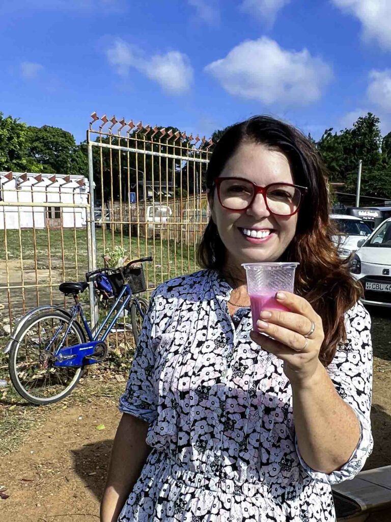 Foreigner woman drinking Jaffna sherbert at the Nallur Kandaswamy Kovil