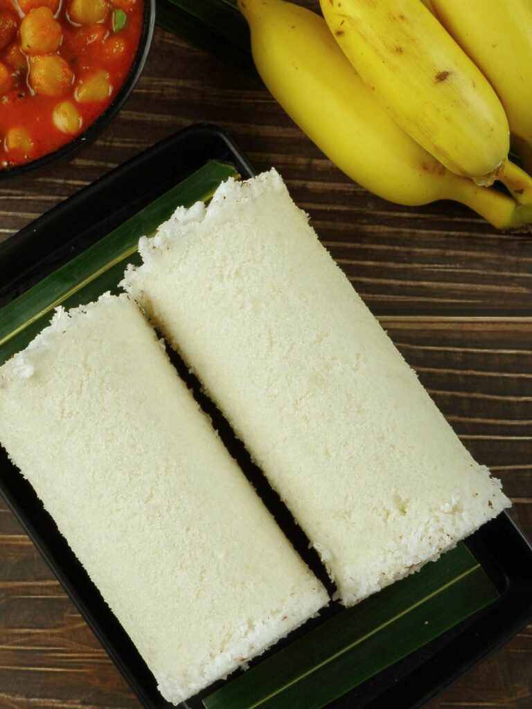 Nallur Kandaswamy food pittu with bananas and curry on dark wood table