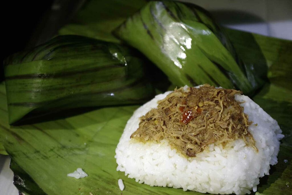 Pastil Filipino Muslim Food steamed rice and shredded chicken on a banana leaf