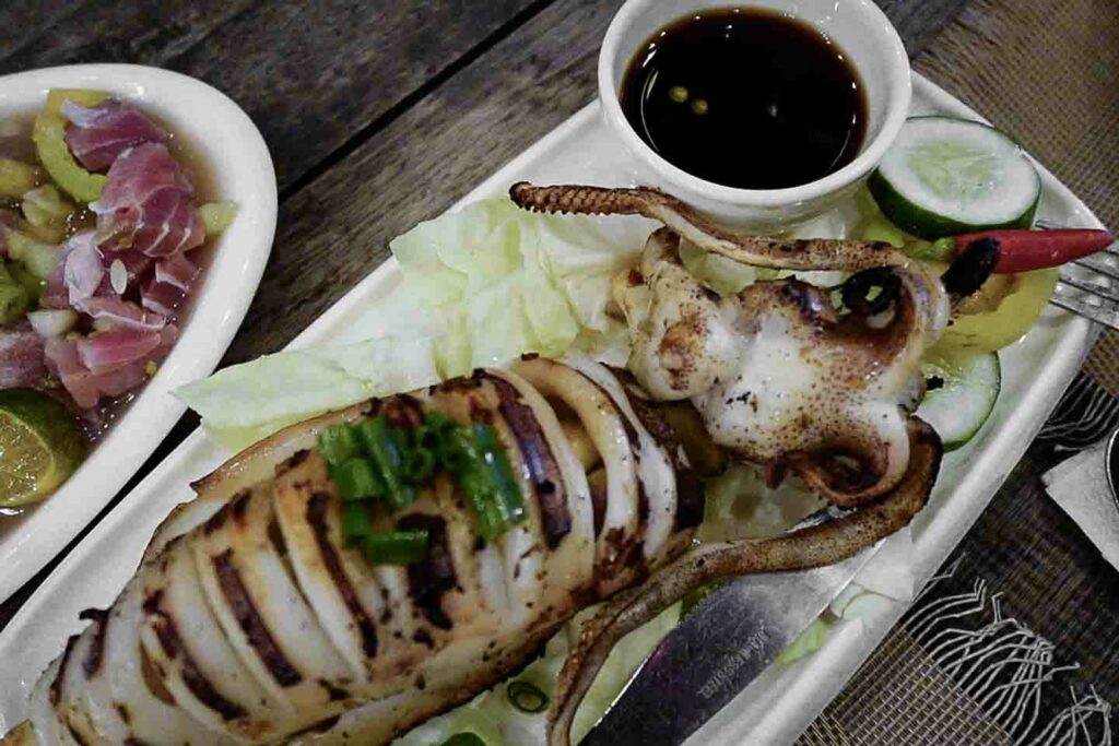 Grilled squid on plate with dipping sauce from AC palayok in Oslob