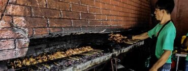 Jo's Inato Chicken being cooked over charcoal by staff. One of the most recommended foods in Dumaguete