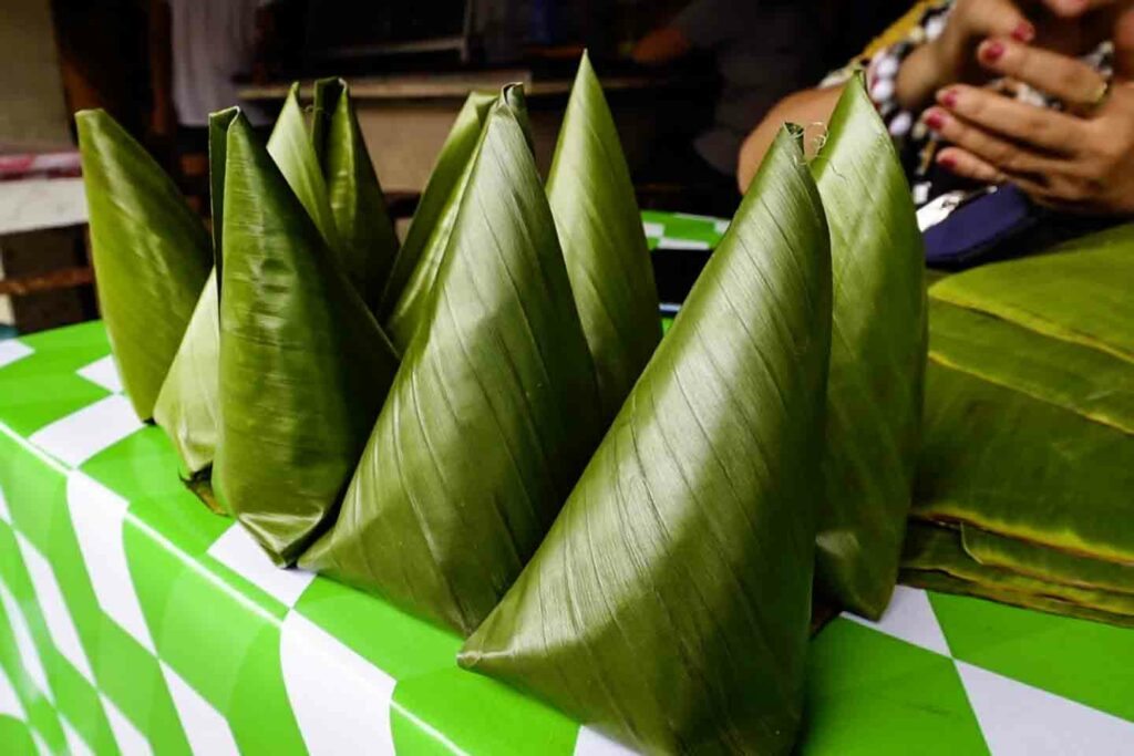 puto maya sweets in cone cylinder banana leaf wrapping at Dumaguete Public market