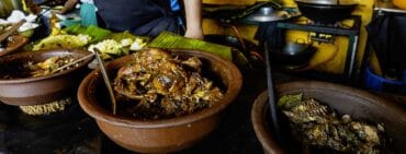 Terracotta bowls of stews and other dishes to be served at Rice and curry restaurant in Kandy