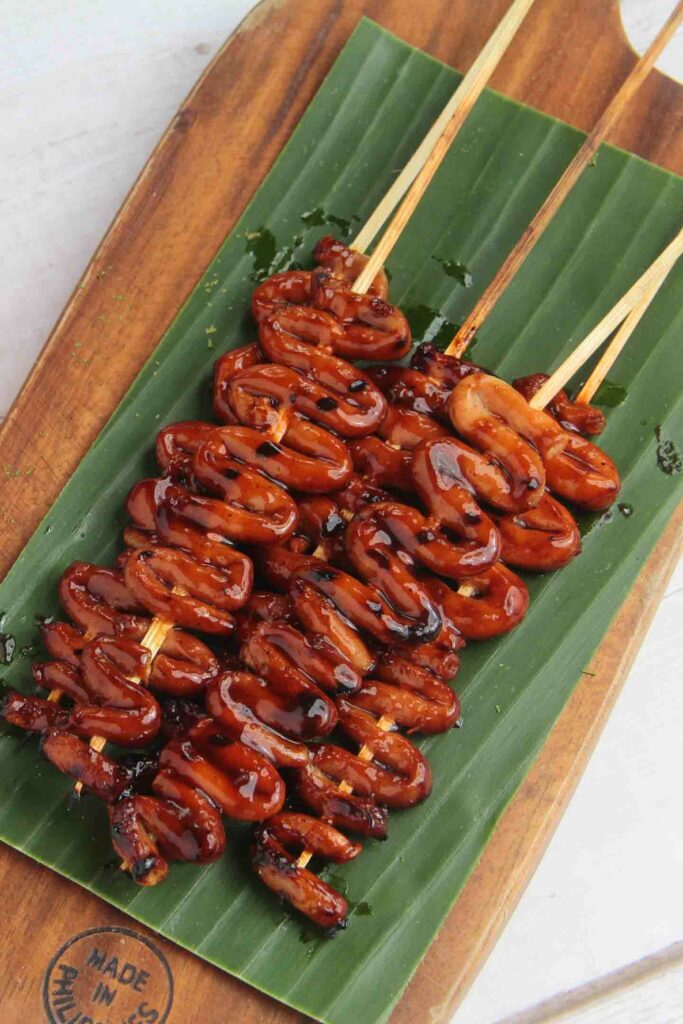 popular foods in Manila Filipino food called Isaw or grilled chicken intestine in barbecue sticks.