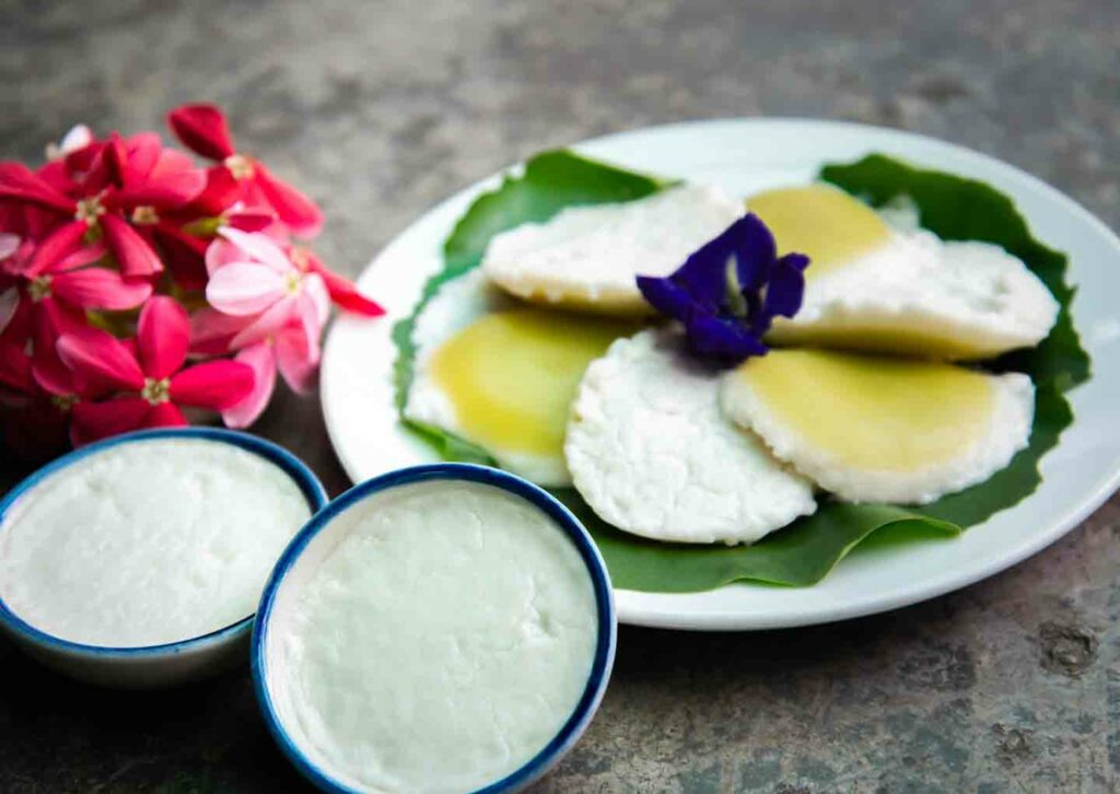 Kanom Touy or Steamed Coconut Milk Custard common Chiang Mai foods on table with flowers