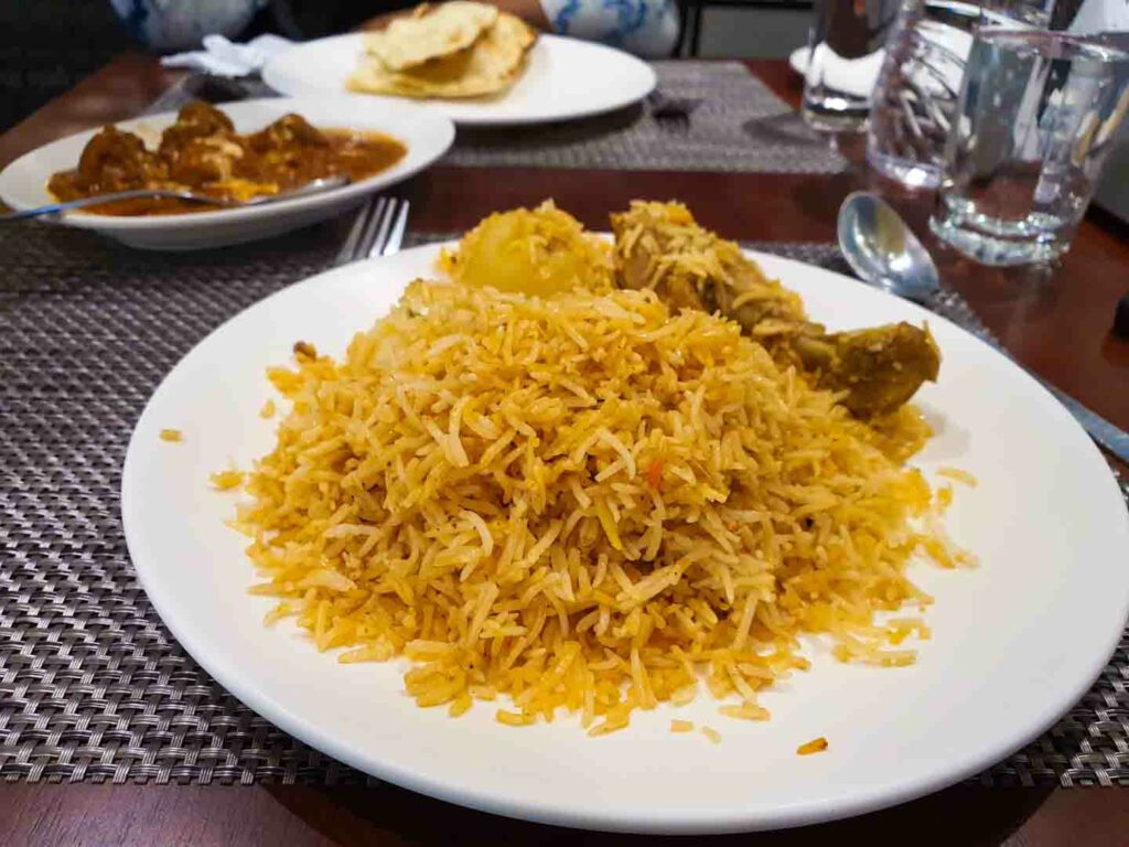 biryani little india singapore on a white plate in a restaurant