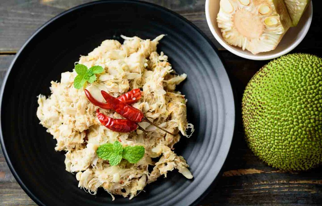 chiang Mai foods Tam Khanun, jackfruit salad on dark wooden table