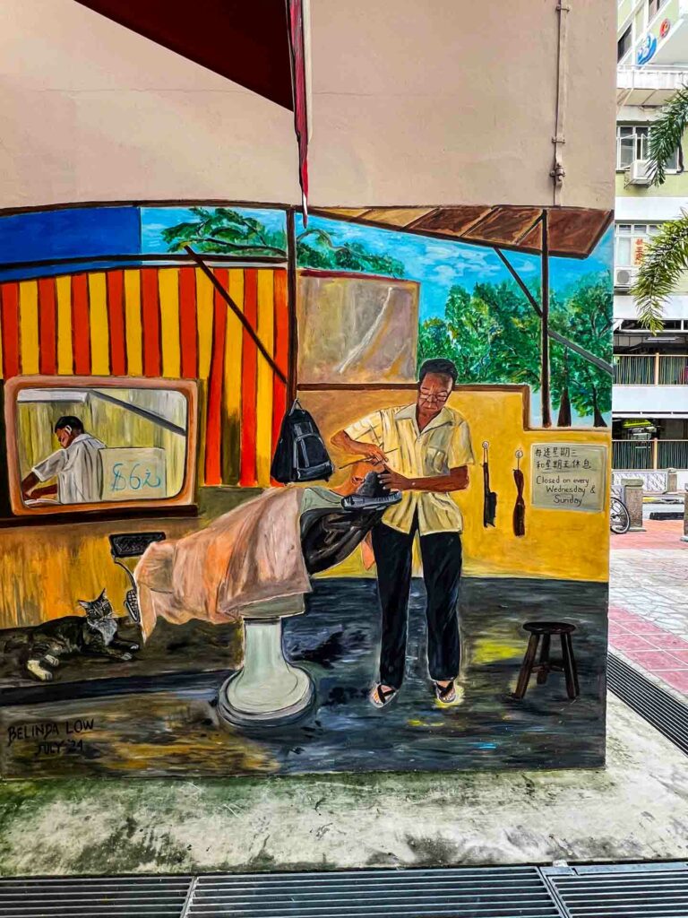 Singapore Chinatown street art with man in barber shop outside