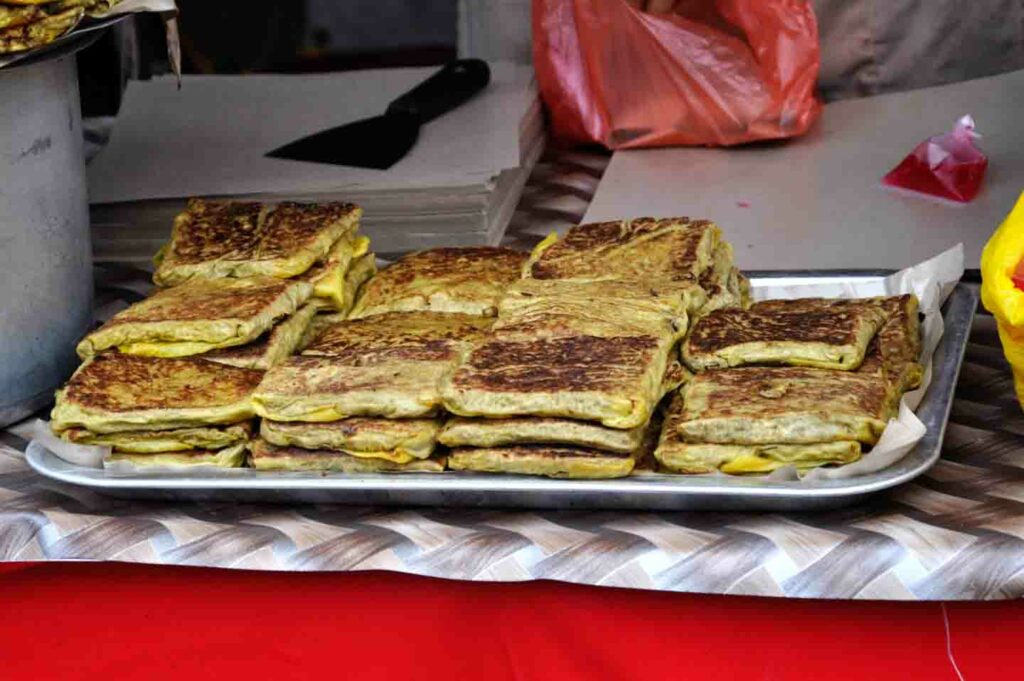 stack of murtabak in Little India Singapore by food cart vendor