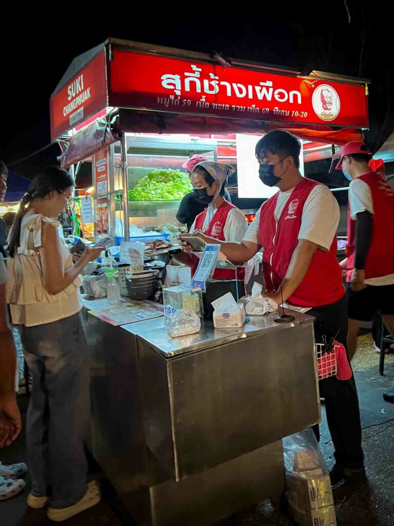 Chiang Mai street market, vendors have their own money taker